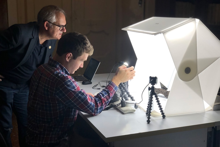 A Herculaneum scroll being scanned inside its scanning case at Diamond Light Source.